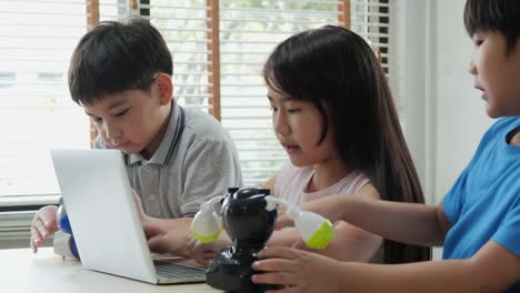 Boy-and-girl-try-to-fixing-robots-in-school-science-club.-Project-for-engineering-club-in-school.-People-with-technology-concept.