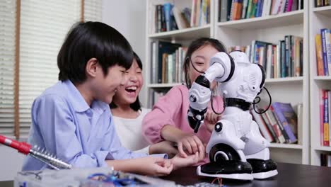 Group-of-student-work-on-a-programable-robot-at-school-science-class-project.-Technology-and-Education-concept.