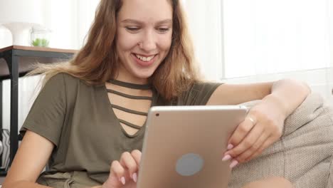 Teenager-Mädchen-mit-digitalen-Tablet-auf-dem-Sofa