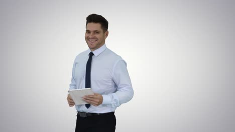 Happy-businessman-walking-in-using-tablet-turning-on-something-or-opening-something-on-gradient-background