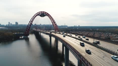 Aerial-view-of-modern-cable-stayed-bridge-through-the-Moscow-river-with-moving-cars-against-cloudy-sky.-Scene.-Moscow-skyline-in-summer