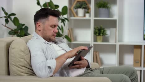 Caucasian-Man-Using-Digital-Tablet-at-Home