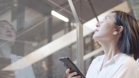 Asian-Young-Woman-Using-Mobile-Phone