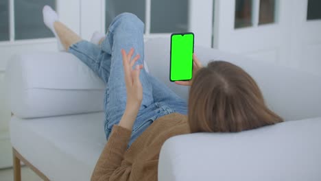 Phone-with-Green-Screen-and-Chroma-Key-Closeup.-Chromakey-Mockup-with-Tracking-Markers-and-Alpha-Matte.-POV-is-Vertical-Template-of-Device-in-Modern-House-Closeup.-Scroll-Up-Online-News-at-Cellphone