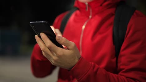 Unrecognizable-person-with-smartphone-in-the-park