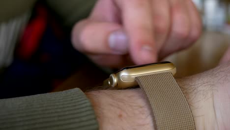 Closeup-of-man-hand-checking-time-and-working-with-smartwatch