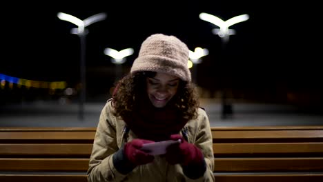 Happy-teenager-sitting-in-park,-watching-and-commenting-photos-in-social-media