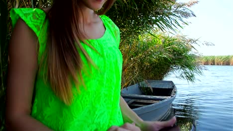 Pretty-young-woman-browsing-social-networks-on-tablet-on-boat