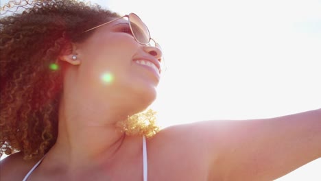 Portrait-of-Ethnic-female-in-sundress-on-beach