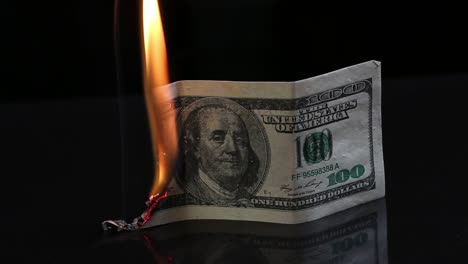 Dollar-bill-in-flames.-American-money-burning-on-black-background.