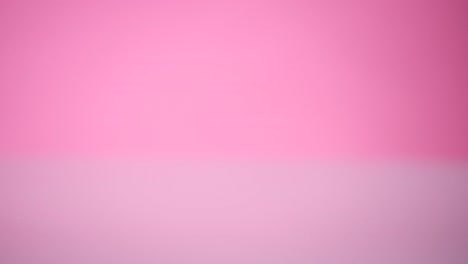 The-egg-falls-and-crashes-on-pink-background