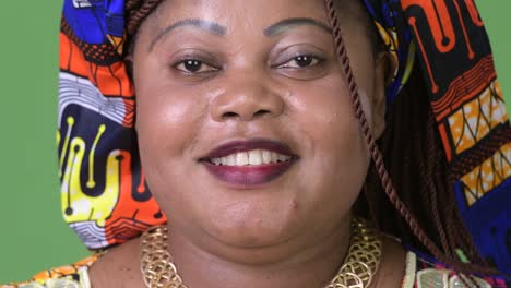 Overweight-beautiful-African-woman-wearing-traditional-clothing-against-green-background