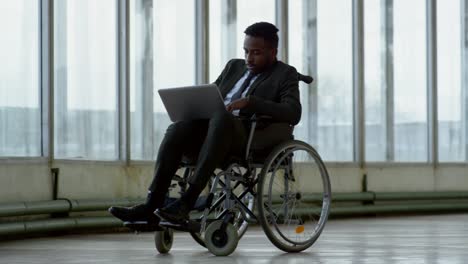 Businessman-in-Wheelchair-Working-on-Laptop