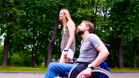 Young-disable-man-walking-in-the-park-with-his-wife