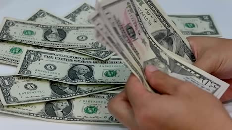 Businessmanâs-hands-counting-US-dollar-money-bills-on-white-background.