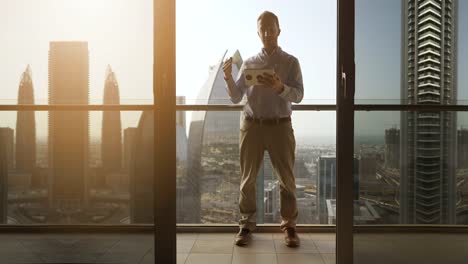 Young-man-using-tablet-to-speak-and-communicate-with-skyscraper-view-background