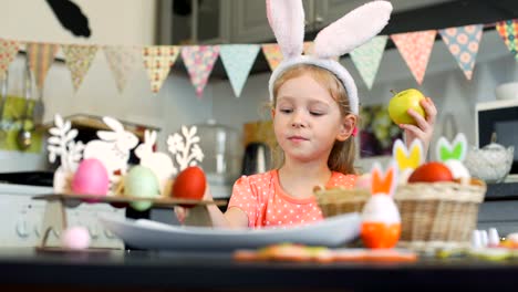 Little-Girl-Eating-Easter-Cookies-and-Apple