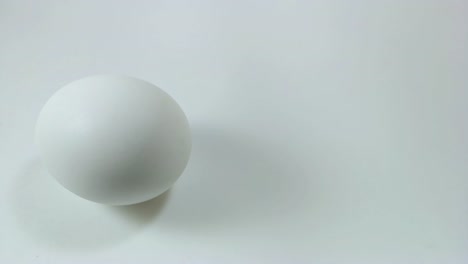 Egg-spinning-and-rolling-on-the-white-table-Easter-egg