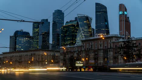 Heavy-traffic-on-the-streets-of-the-city-at-the-end-of-the-day,-against-the-lights-of-downtown,time-lapse