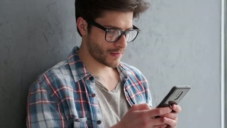 Young-man-text-messaging-on-mobile-phone