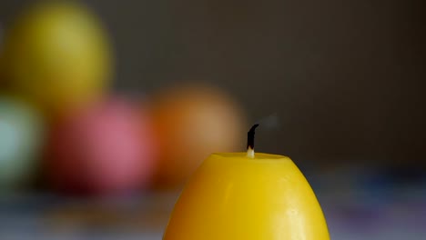 Candles-made-in-shape-of-easter-egg.-Burning-candles.-Yellow-candles-extinguished-from-the-air.