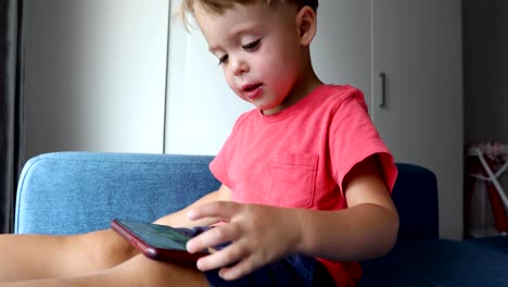 Content-kid-playing-smartphone-on-sofa