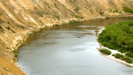 Scenic-landscape.-River-flowing-through-the-forest-and-fields.-4K