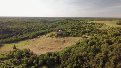 Aerial-view-of-the-Russian-forest,-river-and-steppe-overlooking-an-abandoned-Church-and-architectural-objects