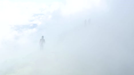 People-hiking-on-active-volcano-with-smoke-and-fumes-in-Kamchatka