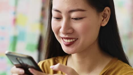 Handheld-view-of-young-woman-with-mobile-phone-at-cafe