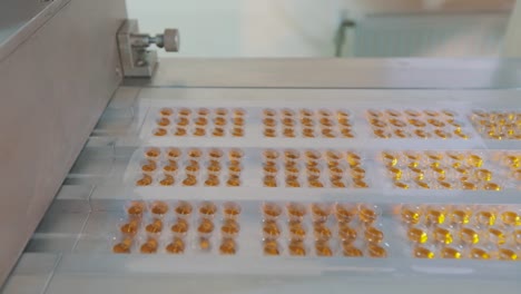 Tablet-manufacturing-process.-Industrial-interior-at-a-pharmaceutical-factory.-Blister-packing-of-tablets.