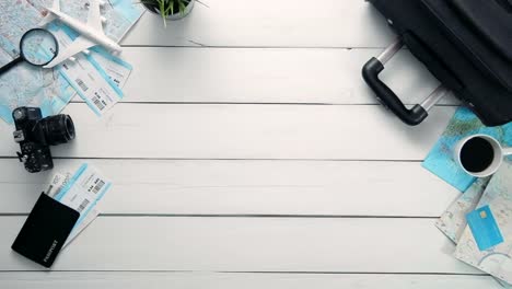 Top-view-time-lapse-hands-laying-on-white-desk-word-"FRANCE"-decorated-with-travel-items