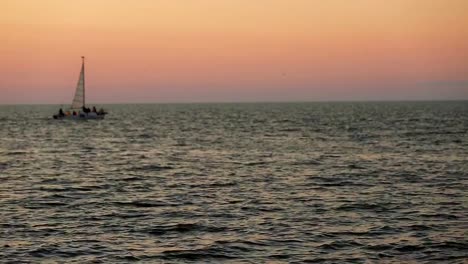 boat-floats-on-the-sea-at-sunset