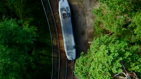 Vertical-top-view-on-The-tram-in-the-green-forest.-Drone-flight