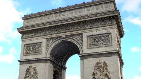 National-French-symbol-Arc-de-Triomphe-against-blue-sky-background,-zoom-out