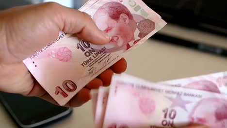 the-person-counting-turkish-banknote.-ten-turkish-lira