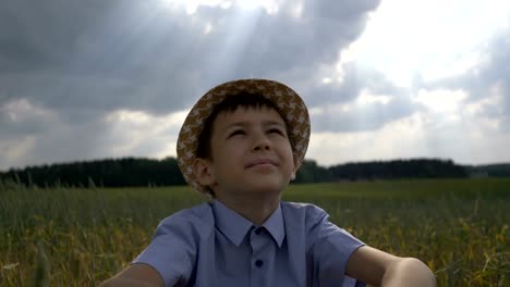 muchacho-soñador-en-el-sombrero-mira-el-hermoso-cielo