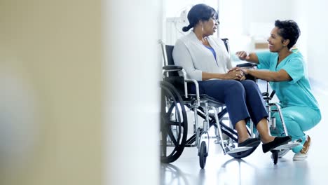 Portrait-of-ethnic-nurse-and-patient-in-wheelchair