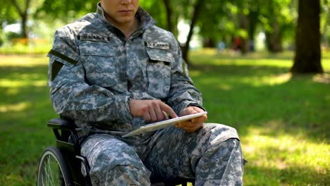 American-serviceman-using-tablet-in-wheelchair,-searching-health-care-service