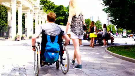 Young-disable-man-walking-in-the-park-with-his-wife