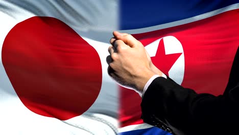 Japan-sanctions-North-Korea,-chained-arms,-political-or-economic-conflict