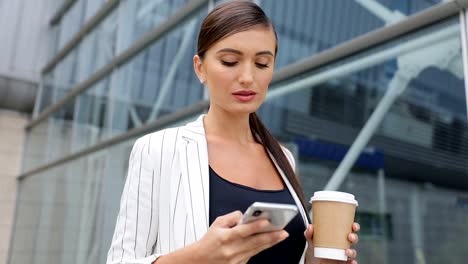 Business-Woman-With-Phone-And-Coffee-Going-To-Work