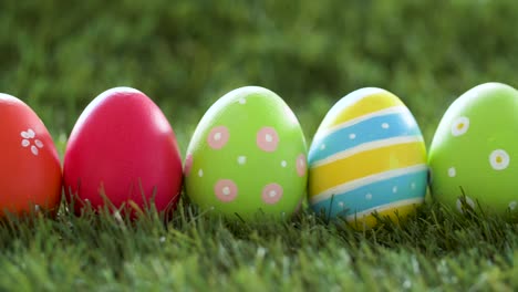 row-of-colored-easter-eggs-on-artificial-grass