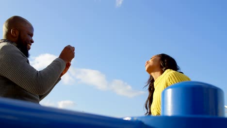 Couple-taking-photo-with-mobile-phone-on-a-sunny-day-4k