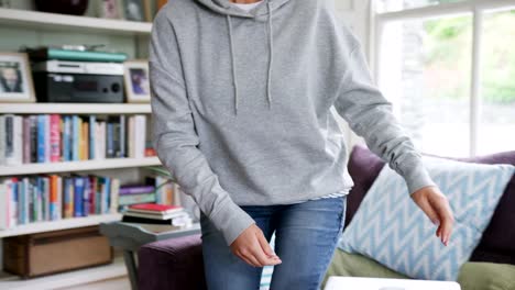 Beautiful-Blond-Woman-Using-Laptop-In-Her-Living-Room