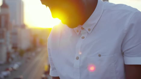 Smiling-African-Man-Watching-Video-on-Smartphone-on-Rooftop