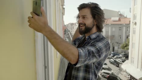 Happy-young-man-gesturing-and-talking-during-video-call.