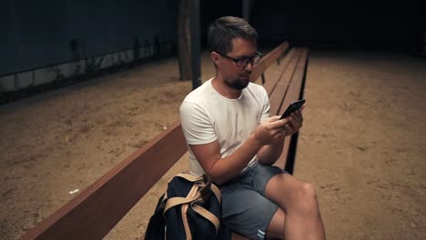 Man-with-smartphone-at-night-in-city.