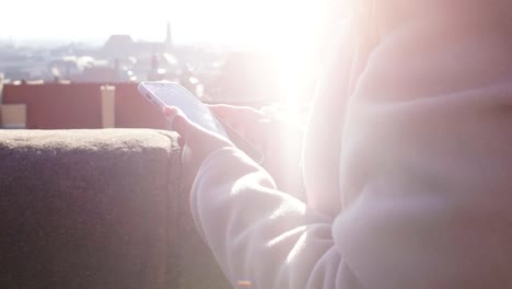 Female-sharing-pictures-in-social-networks-on-phone,-free-wi-fi-on-roof-terrace