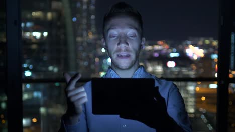 Caucasian-man-using-digital-tablet-for-internet-and-communications-with-cityscape-background